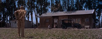 Movie still from “East of Eden” (1955), directed by Elia Kazan – Two children are standing outside of a house; Extreme Wide shot, Low angle