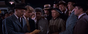 Movie still from “East of Eden” (1955), directed by Elia Kazan – A group of men and women standing next to each other; Medium shot, High angle