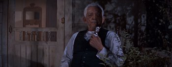 Movie still from “East of Eden” (1955), directed by Elia Kazan – An older man holding a pipe in his mouth; Close Up shot, Low angle