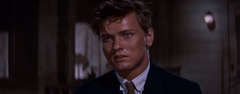 Movie still from “East of Eden” (1955), directed by Elia Kazan – A person wearing a suit and tie; Close Up shot, Over the shoulder angle