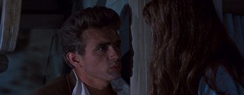 Movie still from “East of Eden” (1955), directed by Elia Kazan – A man and a woman looking at one another; Close Up shot, Over the shoulder angle