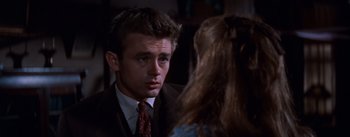 Movie still from “East of Eden” (1955), directed by Elia Kazan – A man in a business suit and a woman in a dress suit; Close Up shot, Over the shoulder angle