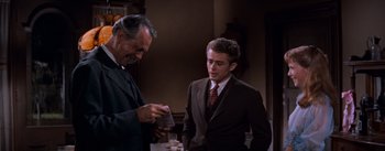 Movie still from “East of Eden” (1955), directed by Elia Kazan – A man in a suit and tie standing next to another man in a suit and tie; Medium shot, Over the shoulder angle