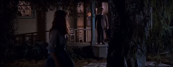 Movie still from “East of Eden” (1955), directed by Elia Kazan – A man and a woman standing in front of a house; Wide shot, Low angle