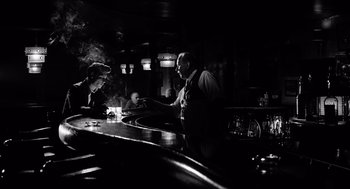 Movie still from “Ed Wood” (1994), directed by Tim Burton – A man standing at a counter in a bar; Medium shot, Over the shoulder angle