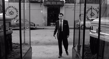 Movie still from “Ed Wood” (1994), directed by Tim Burton – A black and white photo of a man in a suit and tie; Wide shot, Low angle