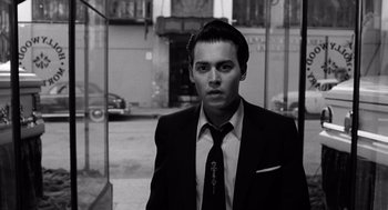 Movie still from “Ed Wood” (1994), directed by Tim Burton – Black and white photograph of a man in a suit and tie; Close Up shot, Low angle