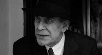 Movie still from “Ed Wood” (1994), directed by Tim Burton – An older man wearing a suit and a hat; Close Up shot, Low angle