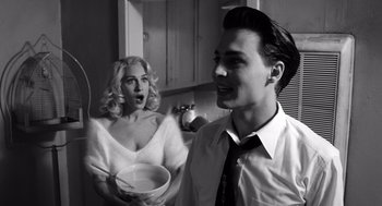 Movie still from “Ed Wood” (1994), directed by Tim Burton – A man and a woman in a kitchen with a bowl of cereal; Medium shot, Low angle