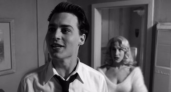 Movie still from “Ed Wood” (1994), directed by Tim Burton – A man and a woman standing next to each other in a room; Close Up shot, Over the shoulder angle