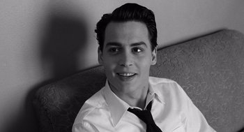 Movie still from “Ed Wood” (1994), directed by Tim Burton – A man in a white shirt and a black tie; Close Up shot, High angle