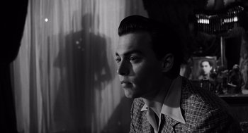 Movie still from “Ed Wood” (1994), directed by Tim Burton – A black and white photo of a man in a suit; Close Up shot, Low angle