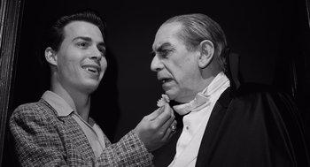 Movie still from “Ed Wood” (1994), directed by Tim Burton – An older man putting a bow tie on a younger man; Close Up shot, Over the shoulder angle