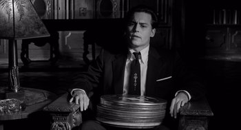 Movie still from “Ed Wood” (1994), directed by Tim Burton – A black and white photo of a man in a suit and tie; Medium shot, High angle