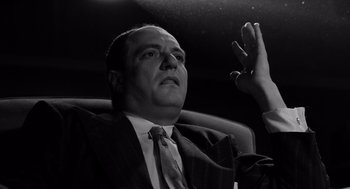 Movie still from “Ed Wood” (1994), directed by Tim Burton – Black and white photograph of a man in a suit; Close Up shot, Low angle