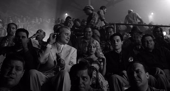 Movie still from “Ed Wood” (1994), directed by Tim Burton – A group of people sitting in a room; Medium shot, Low angle