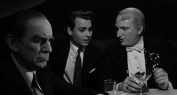 Movie still from “Ed Wood” (1994), directed by Tim Burton – A group of men sitting around a table; Close Up shot, High angle
