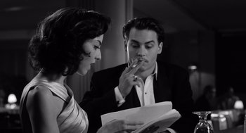 Movie still from “Ed Wood” (1994), directed by Tim Burton – A man and a woman are looking at a piece of paper; Close Up shot, Over the shoulder angle
