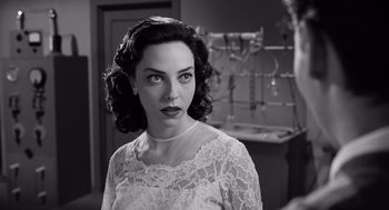 Movie still from “Ed Wood” (1994), directed by Tim Burton – Black and white photograph of a woman wearing a white dress; Close Up shot, Over the shoulder angle