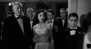 Movie still from “Ed Wood” (1994), directed by Tim Burton – A group of men and a woman standing in front of a building; Medium shot, Over the shoulder angle