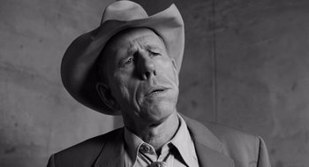 Movie still from “Ed Wood” (1994), directed by Tim Burton – An older man wearing a cowboy hat and a suit; Close Up shot, Low angle
