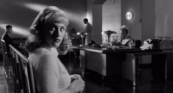 Movie still from “Ed Wood” (1994), directed by Tim Burton – Black and white photograph of a woman sitting in front of two men; Medium shot, Over the shoulder angle