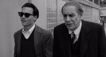 Movie still from “Ed Wood” (1994), directed by Tim Burton – A man and a man in a suit and tie standing next to each other; Close Up shot, Over the shoulder angle