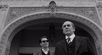 Movie still from “Ed Wood” (1994), directed by Tim Burton – A man and a woman standing next to each other in front of a building; Medium shot, Low angle