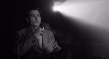 Movie still from “Ed Wood” (1994), directed by Tim Burton – A black and white photo of a man smoking a cigarette; Close Up shot, Low angle