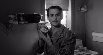 Movie still from “Ed Wood” (1994), directed by Tim Burton – A man holding a tub of ice cream in his hand; Close Up shot, High angle