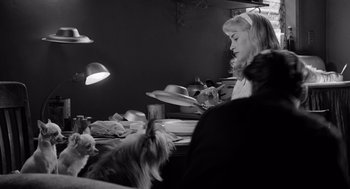 Movie still from “Ed Wood” (1994), directed by Tim Burton – A black and white photo of a woman and a dog; Medium shot, Over the shoulder angle