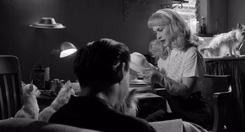 Movie still from “Ed Wood” (1994), directed by Tim Burton – A black - and - white photo of a woman and a man; Medium shot, Over the shoulder angle