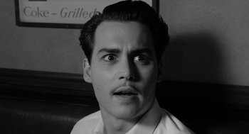 Movie still from “Ed Wood” (1994), directed by Tim Burton – A black and white photo of a man with a surprised look on his face; Close Up shot, High angle
