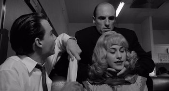 Movie still from “Ed Wood” (1994), directed by Tim Burton – A man and a woman with another man looking at them; Close Up shot, Over the shoulder angle