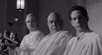 Movie still from “Ed Wood” (1994), directed by Tim Burton – A group of men standing next to each other; Medium shot, Low angle