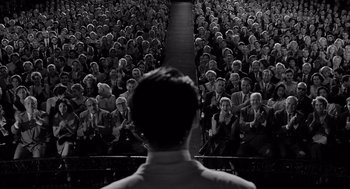 Movie still from “Ed Wood” (1994), directed by Tim Burton – A man standing in front of a group of people; Extreme Wide shot, High angle