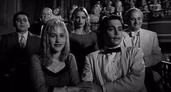 Movie still from “Ed Wood” (1994), directed by Tim Burton – A group of people sitting in a room; Medium shot, Low angle