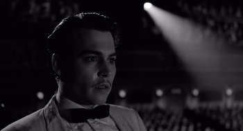 Movie still from “Ed Wood” (1994), directed by Tim Burton – A black and white photo of a man in a tuxedo; Close Up shot, Low angle