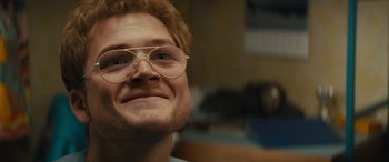 Movie still from “Eddie the Eagle” (2015), directed by Dexter Fletcher – A person wearing glasses; Close Up shot, Low angle