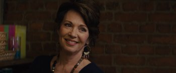 Movie still from “Eddie the Eagle” (2015), directed by Dexter Fletcher – A person with a brick wall in the background; Close Up shot, Over the shoulder angle