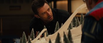 Movie still from “Eddie the Eagle” (2015), directed by Dexter Fletcher – A person looking at a cake; Close Up shot, Over the shoulder angle