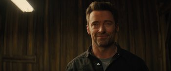 Movie still from “Eddie the Eagle” (2015), directed by Dexter Fletcher – A person wearing a jacket; Close Up shot, Over the shoulder angle