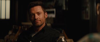 Movie still from “Eddie the Eagle” (2015), directed by Dexter Fletcher – A person wearing a black shirt; Close Up shot, Over the shoulder angle