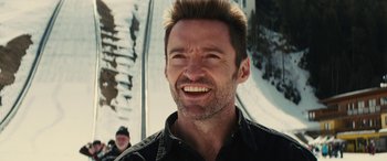 Movie still from “Eddie the Eagle” (2015), directed by Dexter Fletcher – A person on a ski slope; Close Up shot, Over the shoulder angle