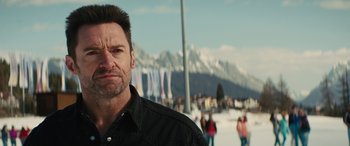 Movie still from “Eddie the Eagle” (2015), directed by Dexter Fletcher – A person wearing a black shirt; Close Up shot, Over the shoulder angle