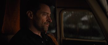 Movie still from “Eddie the Eagle” (2015), directed by Dexter Fletcher – A person sitting in a chair; Close Up shot, Over the shoulder angle