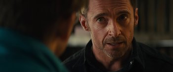 Movie still from “Eddie the Eagle” (2015), directed by Dexter Fletcher – A person looking at another person; Close Up shot, Over the shoulder angle