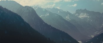 Movie still from “Eddie the Eagle” (2015), directed by Dexter Fletcher – A view of a mountain range with a lot of snow on it; Extreme Wide shot, Low angle