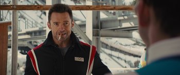 Movie still from “Eddie the Eagle” (2015), directed by Dexter Fletcher – A person holding a cigarette in his mouth; Close Up shot, Over the shoulder angle