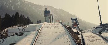 Movie still from “Eddie the Eagle” (2015), directed by Dexter Fletcher – A view of a ski slope from a ski lift; Extreme Wide shot, High angle